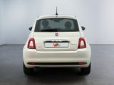 the back end of a white fiat car parked in a white room