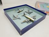 four model airplanes in a blue box on a table