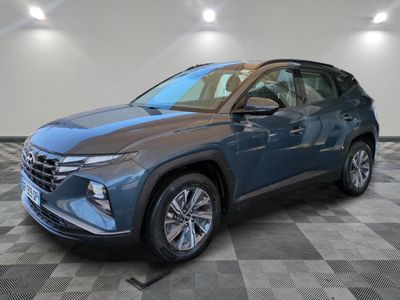 a blue 2020 hyundai kona suv parked in a showroom