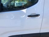 a close up of a white van with a black door handle