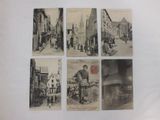 four old black and white photographs of people walking down a street