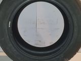 tire on the floor of a car with a white wall in the background