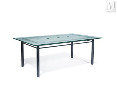 a glass table with metal legs and a glass top