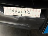 a sticker on the bumper of a car with a measuring tape attached to it