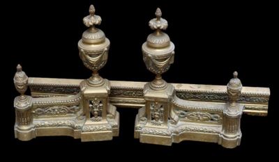 pair of antique brass candlesticks on a black background