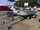 a boat on a trailer parked in a parking lot