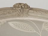 a close up of a chair with a floral design on it