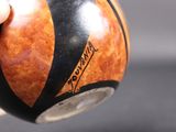 a person holding a wooden ball in their hand