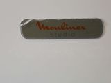 a picture of a metal name plate with a red writing on it