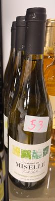 several bottles of wine on a shelf in a store