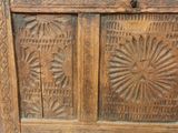 an old wooden cabinet with carvings on it