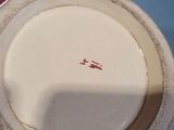 a white plate that has a red line on it