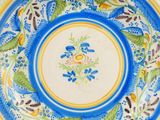 an image of a blue and yellow plate with flowers