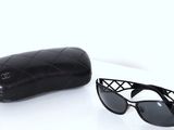 chanel sunglasses and case on a white background