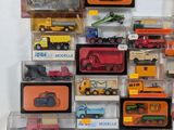 many different types of toy trucks on display in a display case