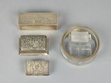 three pieces of silver and glass are sitting on a white surface