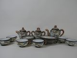 a lot of cups and saucers that are sitting on a table