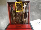 une boîte à outils rouge avec des outils sur une table