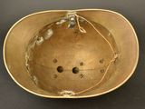 an old helmet on a black table with a string around it