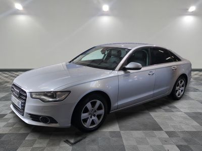 the silver audi is parked in a large room with a checkered floor