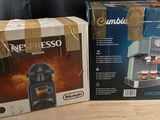 two boxes of coffee machines sitting on a table