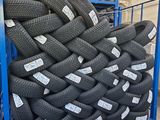 tires stacked on a rack in a warehouse with labels on them