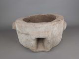 a stone bowl with a hole in the middle of it