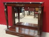 a wooden table with a mirror on top of it