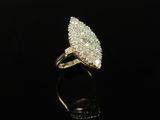 a gold and diamond ring on a black surface