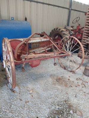 an old tractor that is sitting in a garage
