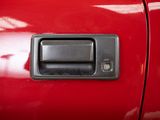 a close up of a door handle on a red car