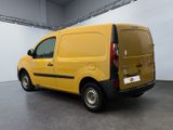 the yellow van is parked in the large room of the building