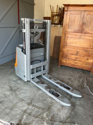 a picture of a forklift truck parked in a garage