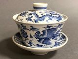 a close up of a blue and white bowl and saucer on a table