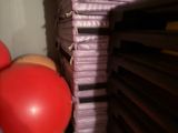 a stack of balloons and a stack of books on a shelf
