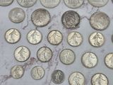 a lot of coins that are on a marble table