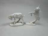 two figurines of a bull and a cow on a table