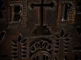 a close up of a wooden box with a cross on it