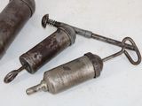 three old tools that are sitting on a table