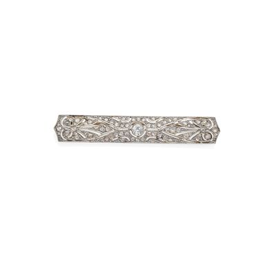 a close up of a silver and diamond bar broochle
