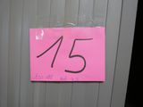 a pink sign on the door of a bathroom