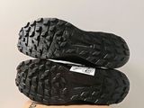the soles of a pair of black shoes on top of a cardboard box