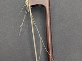 a close up of a wooden stick with a long stick sticking out of it