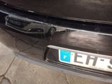 a close up of a black car with a license plate on it