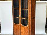 an image of a wooden cabinet with glass doors in a room