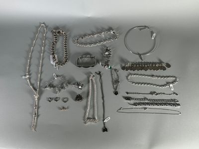 a lot of silver jewelry on the table