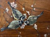 two birds sitting on a branch of a cherry tree