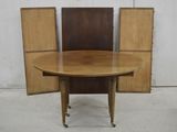 a wooden table with two chairs around it