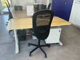 a desk with a chair and a computer on it