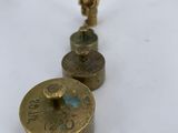 two antique brass candles are sitting on a white table